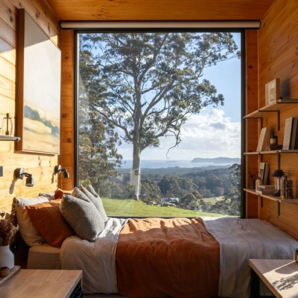Inside of cabin with view of the sea and trees
